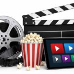 May 2026 theatre and OTT releases editorial illustration featuring film reel, clapperboard, popcorn and streaming platform visuals on white background